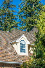 The top of the house or apartment building with nice window.