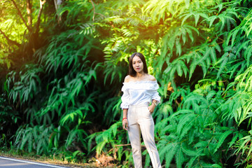 Woman with fern bush in background