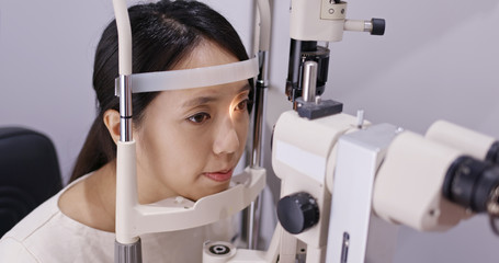 Asian Woman do eye test at clinic