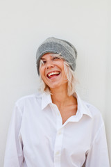 Beautiful happy young woman in warm grey beanie.