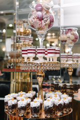 Delicious wedding reception candy bar dessert table. macaroon on candy bar, candy bar on holiday, candy bar at the wedding