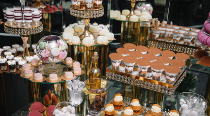 Delicious wedding reception candy bar dessert table. macaroon on candy bar, candy bar on holiday, candy bar at the wedding