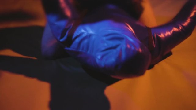 Boxer with gloves throws punches by his hands fists on mannequin sandbag, MMA or Muay Thai fighter training with wrestling doll, man warming up and boxing on mats before the ufc or Tae Kwon Do combat