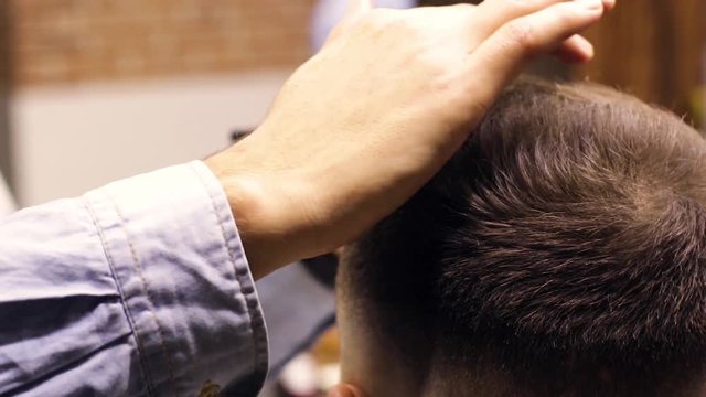 Man barber makes hair styling client. Style concept, hairdresser, salon.