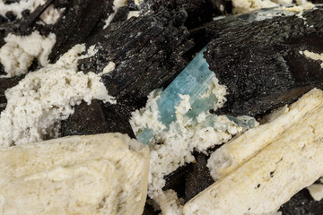 Macro mineral stone Feldspar and Aquamarine and Tourmaline on a white background