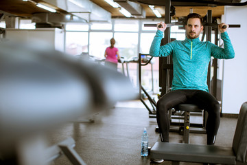 Fototapeta na wymiar Adult man work out in training gym