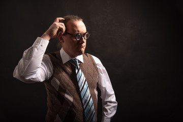 Funny nerd or geek scratches his head looking to empty space