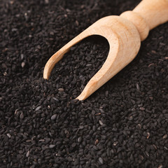 Pile of black sesame seeds on white background