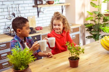 Joyful kids sitting together at the table