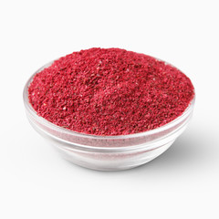 Heap of sumac powder spice isolated on white