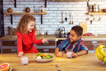 Delighted blonde girl going to feed her friend