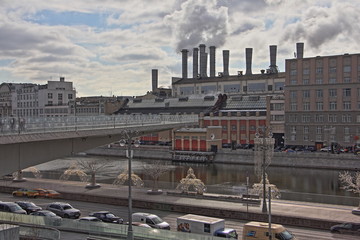 Obraz premium Moscow / Russia – Floating bridge on the Moscow river, Zaryadye Park, view on the background of the power plant pipes