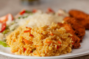 Portion of rice on a plate with other food