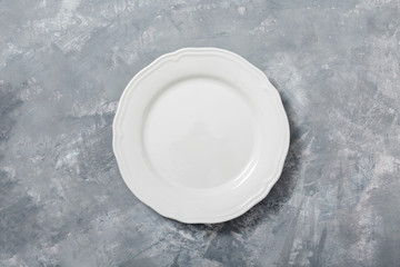 White empty plate on concrete background. 