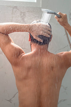 Asian Man Taking A Shower In The Bathroom.