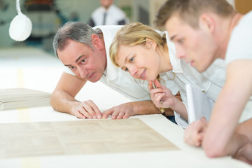 young apprentices with professional carpenter