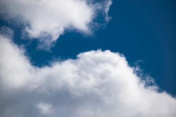 Simple winter blue sky with clouds and without, flying through the air. Natural primitive background, enlarged.