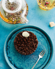 Chocolate tart with white filling. Delicate Chocolate Dessert with Flower Tea.