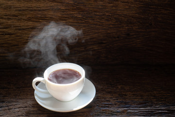 hot coffee and smoke on wood background