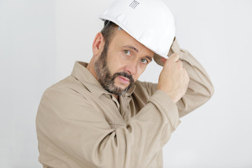 male builder or manual worker in helmet