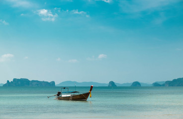Thai traditional wooden boat on the beautiful beach in Krabi province. Thailand.