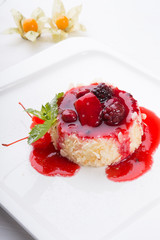 Cake with berries and red syrup