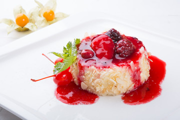Cake with berries and red syrup