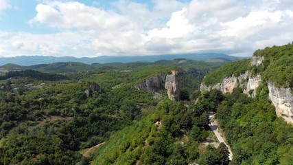 Aerial view of touristic landmark Katskhi Pillar with ancient Orthodox church on top in Chiatura, Georgia