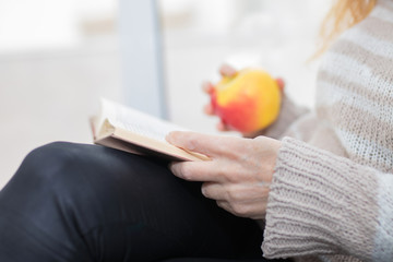 adult woman hands with book, reading