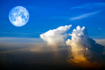 Naklejka na ściany i meble full worm moon back on silhouette heap cloud on sunset sky