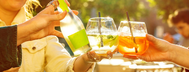 leisure, holidays, eating, people and food concept - happy friends having dinner  and clinking...