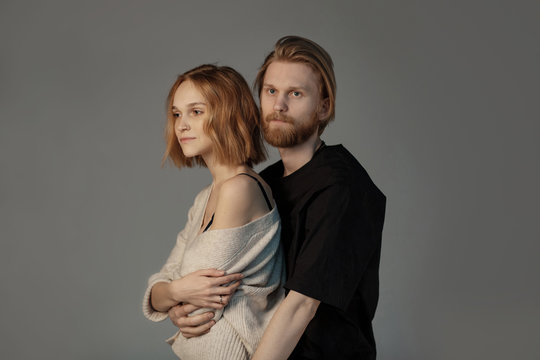 Attractive Bearded Man With Long Brown Hair Hugging Her Beautiful Young Girlfriend