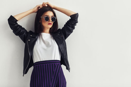 Young Beautiful Woman In A Black Jacket And Sunglasses