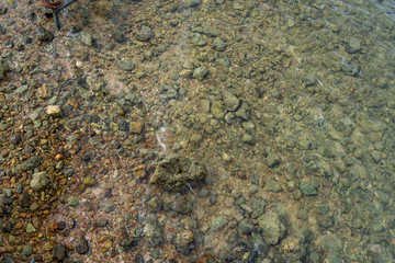 Top view of sea water surface with rock