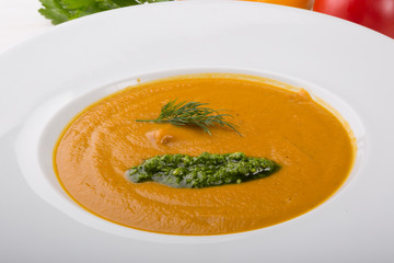 Orange soup puree served with pesto sauce