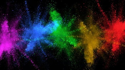 Super slowmotion shot of color powder explosions isolated on black background.