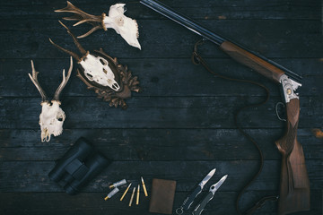 Professional hunters equipment for hunting. Rifle, knives, trophy sculs, ammunition, and others on...