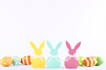 Easter rabbits and painted eggs on white background