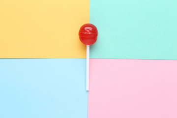 Sweet lollipop on colorful background