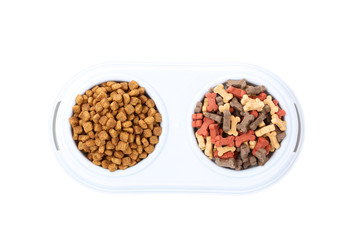 Dry pet food in bowls isolated on white background