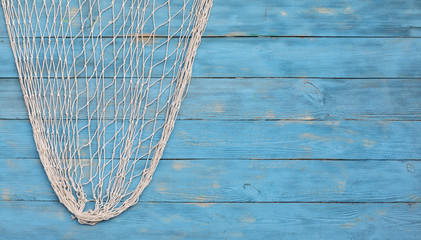 fishing net on a blue wooden