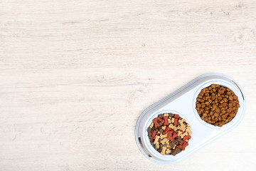 Dry pet food in bowls on the floor