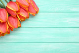 Bouquet of tulips on mint wooden table