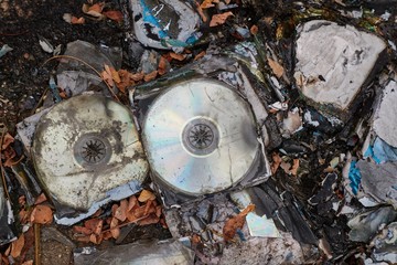 CD's thrown away in garbage dump piles