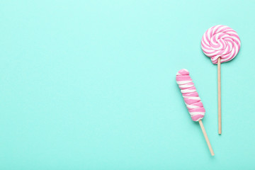 Colorful lollipops on mint background