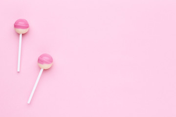 Sweet lollipops on pink background