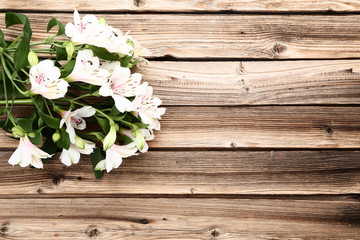 Bouquet of alstroemeria flowers on brown wooden table