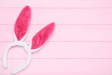 Easter rabbit ears on pink wooden table