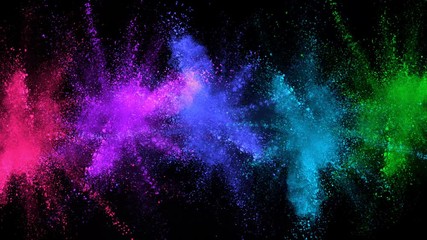 Super slowmotion shot of color powder explosions isolated on black background.