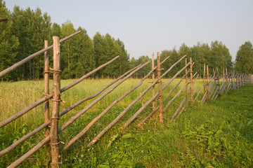 Fototapeta na wymiar Fence in the Arkhangelsk village. Russia